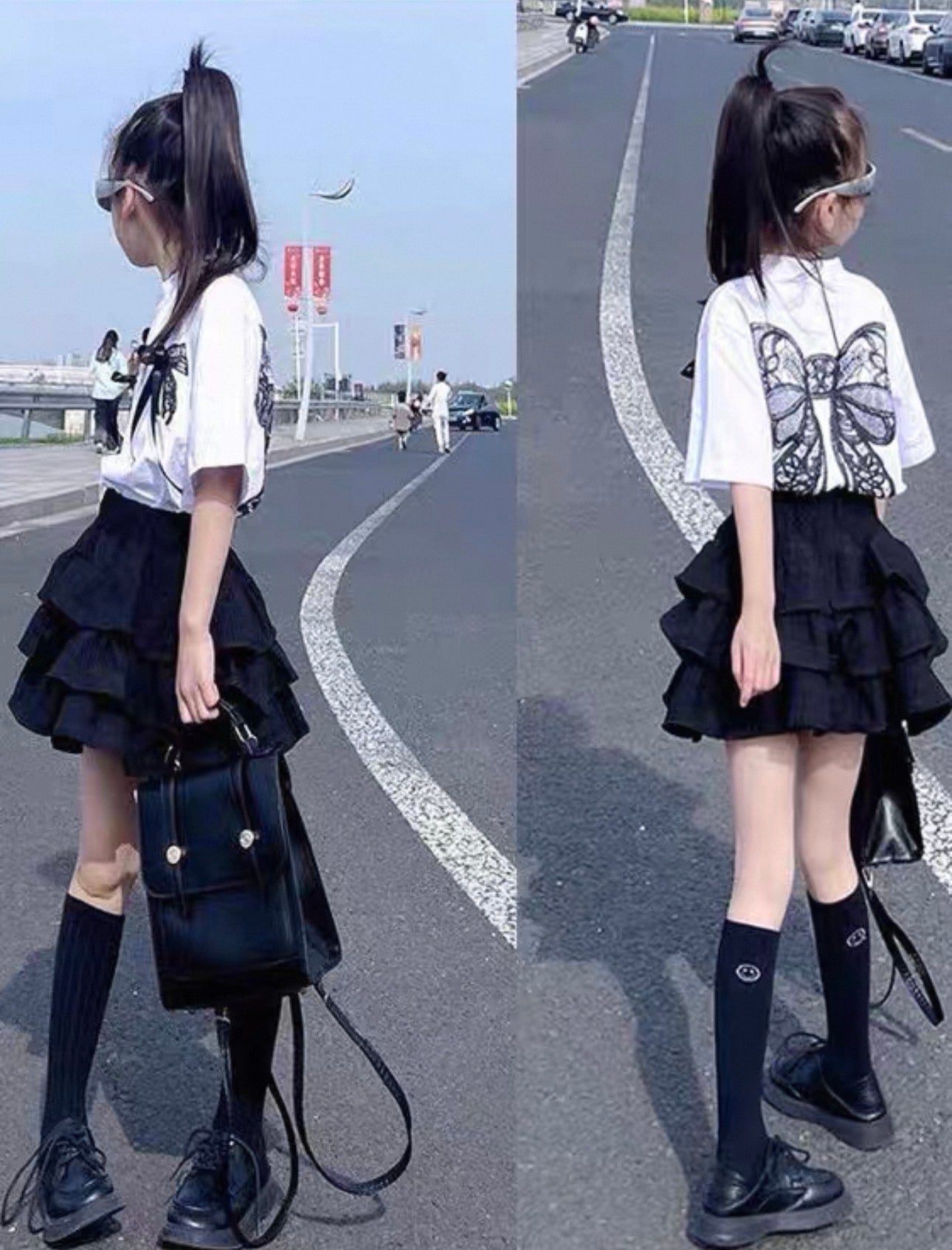 Young girl in a black and white outfit with a butterfly design on a road.