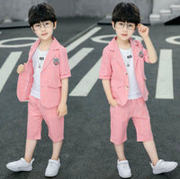Two identical images of a child wearing a pink suit on a road.