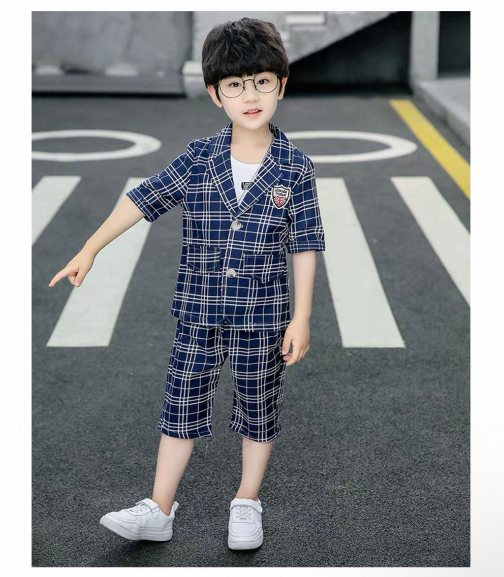Child wearing a blue plaid outfit on a road with white markings