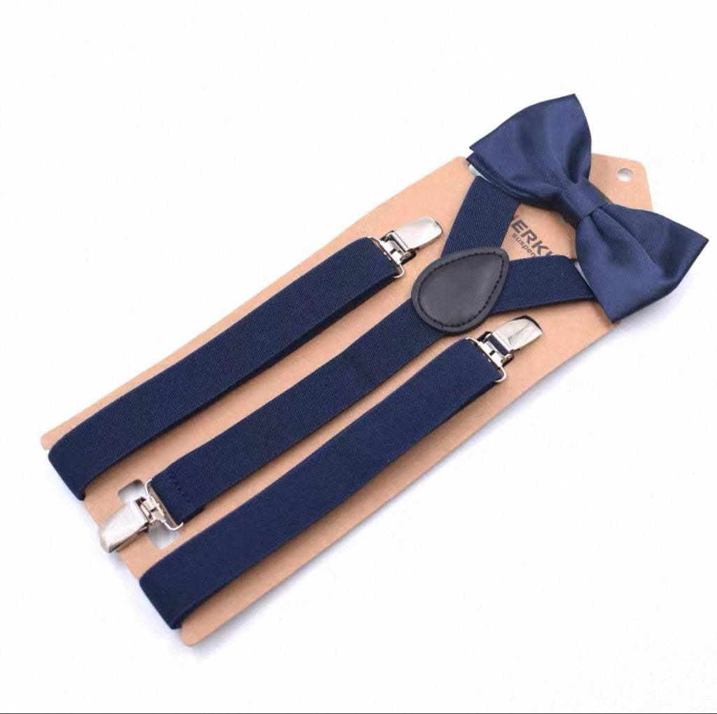Navy blue suspenders and bow tie set on a beige card with visible brand name.