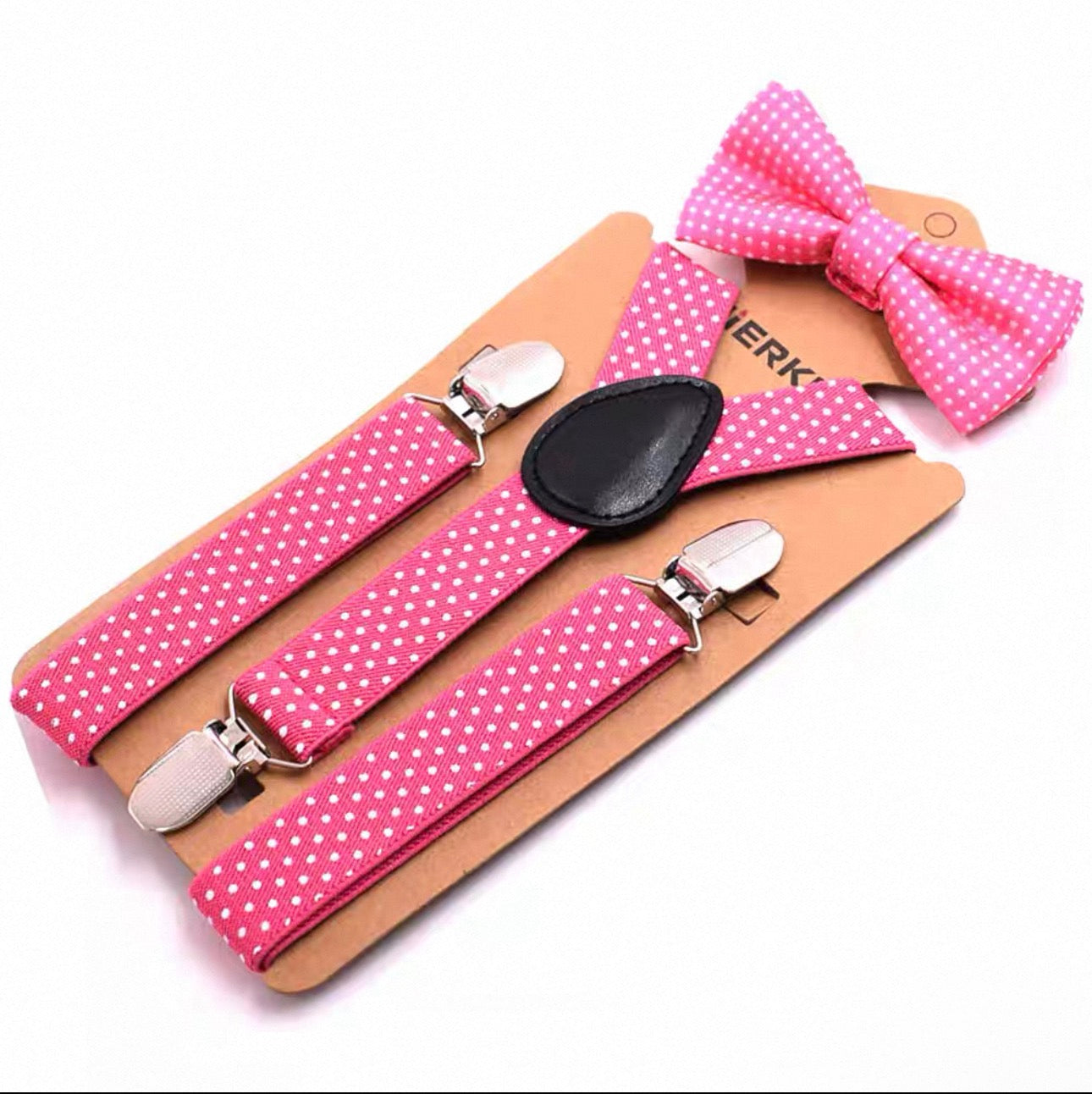 Pink polka dot suspenders and bow tie set on a white background