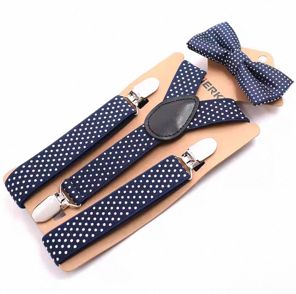 Navy blue suspenders with white polka dots and matching bow tie on a beige card.