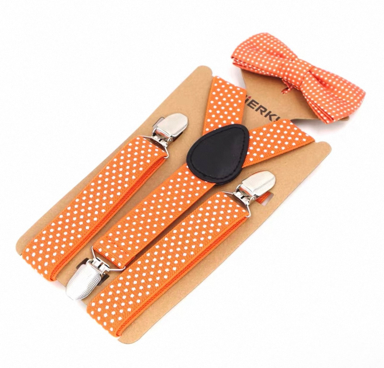 Orange polka dot suspenders with a bow tie on a white background