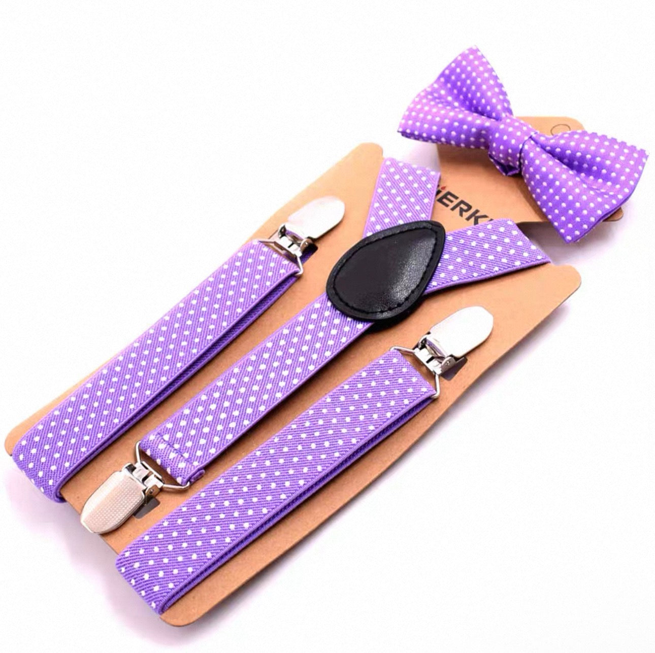 Purple polka dot suspenders and bow tie set on a wooden board with 'Suspenders' branding.