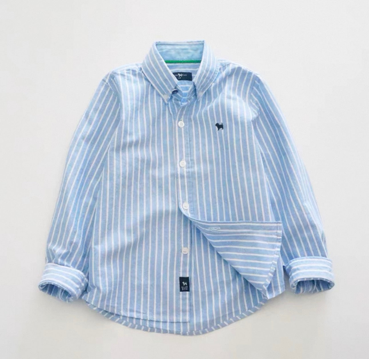 Blue and white striped shirt on a light gray background