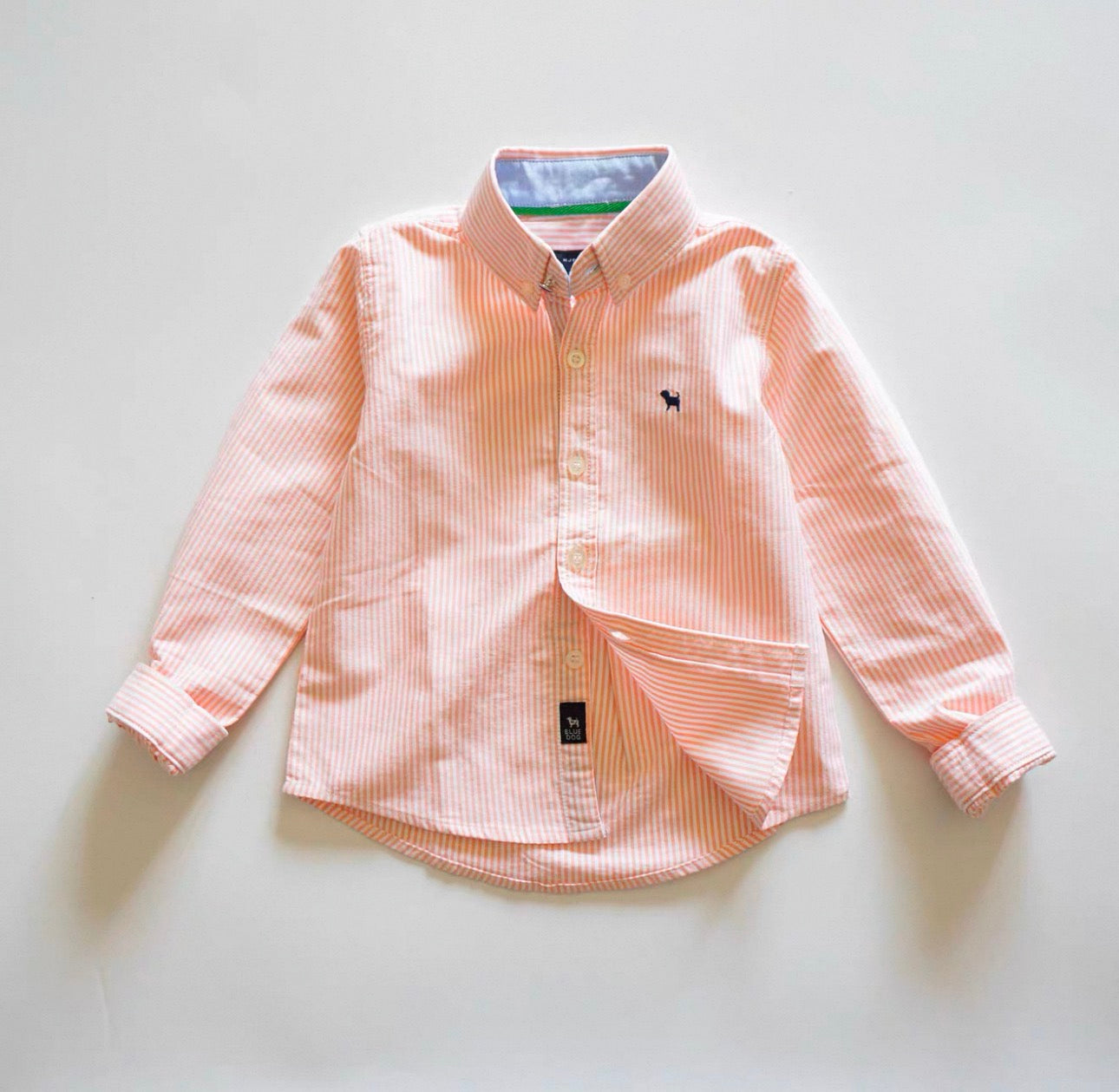 Pink striped shirt on a light gray background