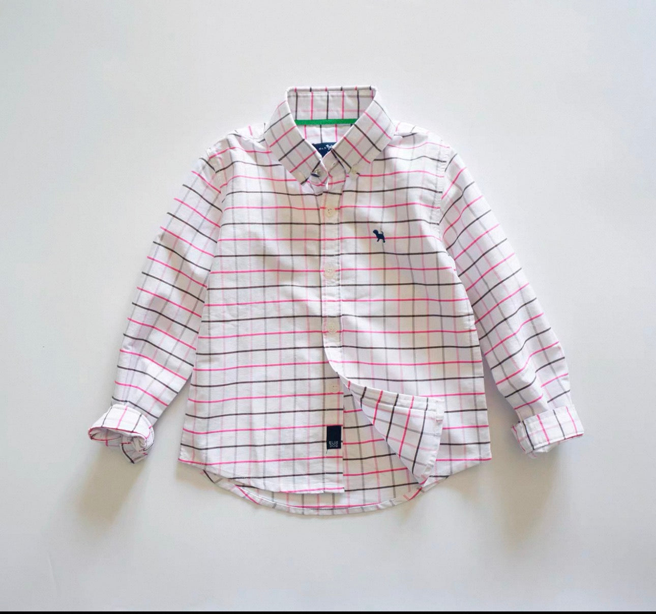 Plaid shirt with a small logo on a light gray background