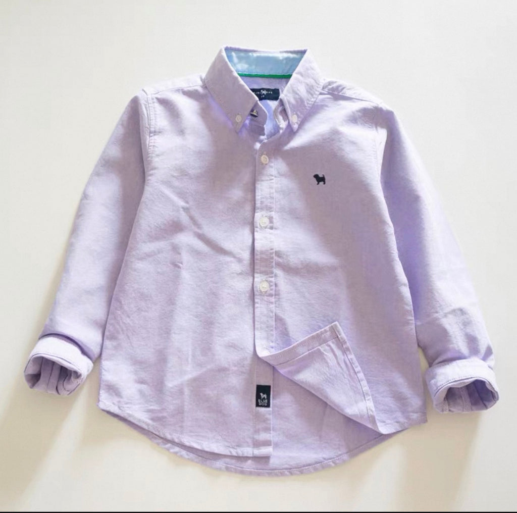 Light purple button-up shirt with a small logo on a light beige background