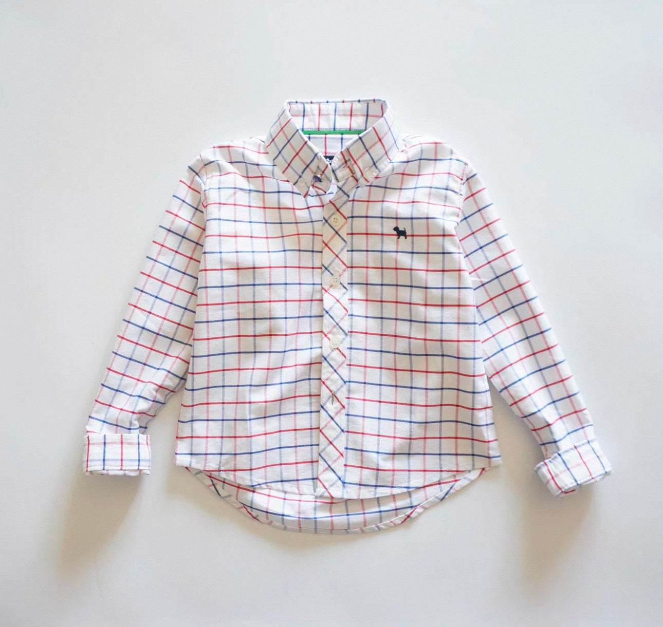 Plaid shirt with a small logo on a light gray background