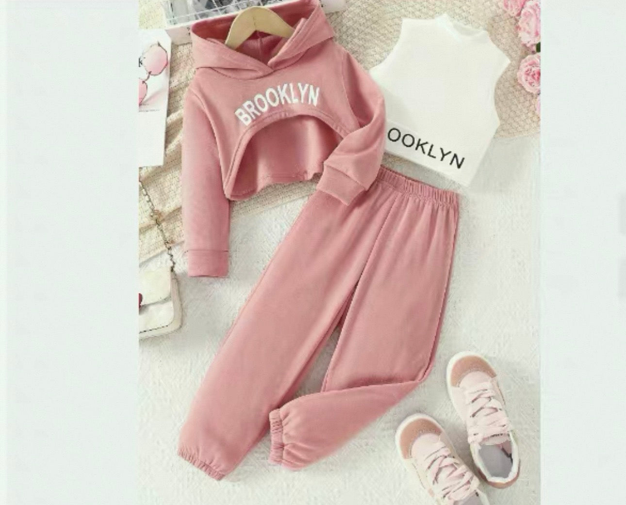 Pink children's hoodie and pants set with 'Brooklyn' text on a light background