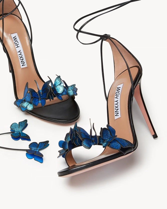 Black stiletto high heels with blue 3D butterfly straps and ankle wrap ties.