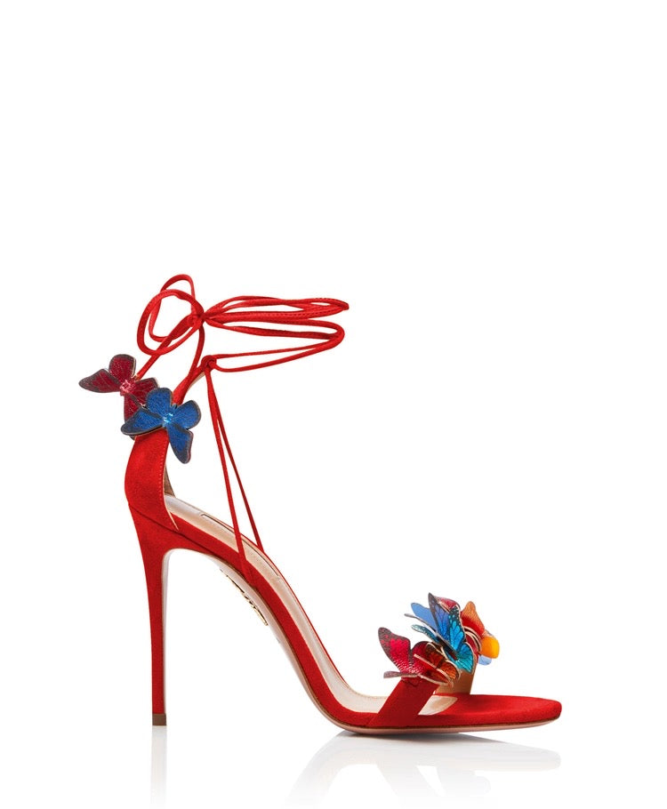 Red stiletto high heel sandal with ankle wrap straps and multicolored butterfly and flower decorations.