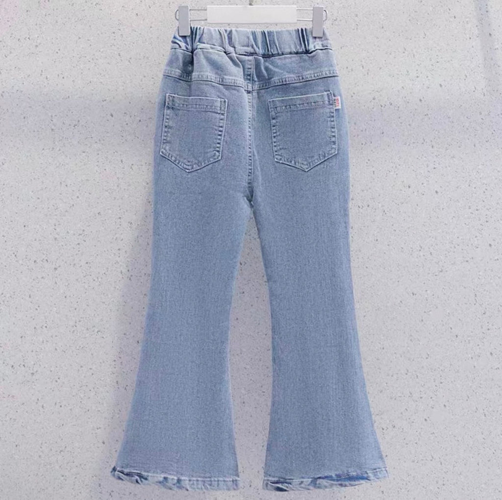 Light blue flared jeans on a white hanger against a light gray background