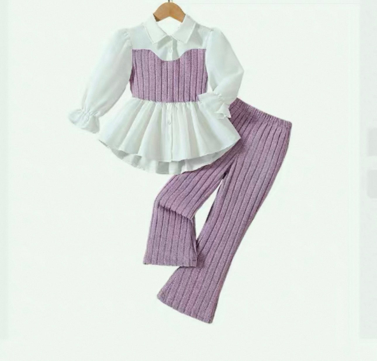 White blouse with ruffled collar and purple checkered pants on a white background
