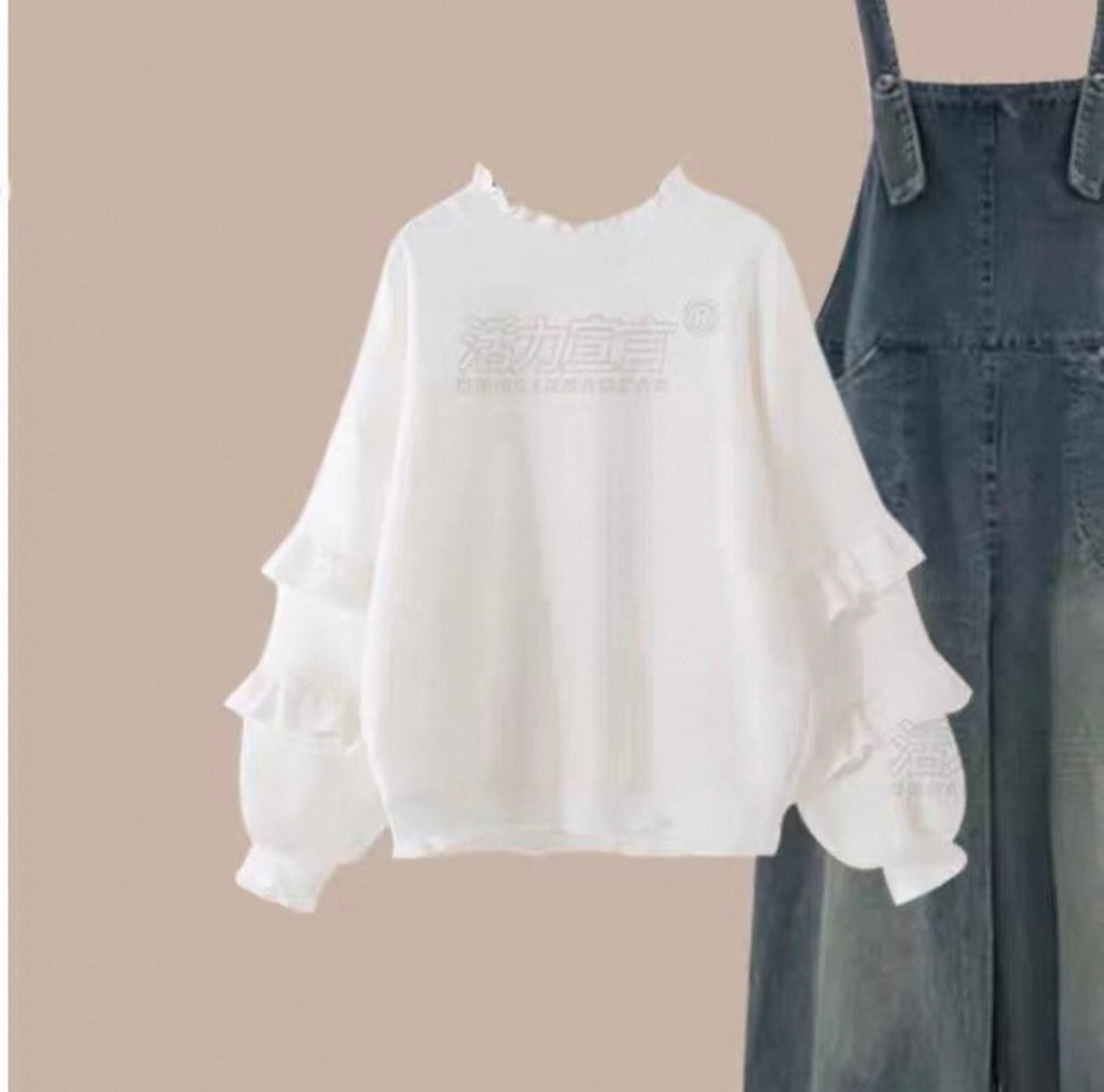 White blouse with ruffled sleeves and denim overalls on a beige background