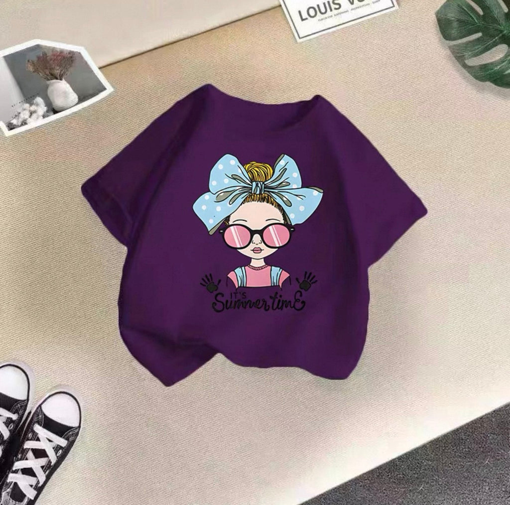 Purple sweatshirt with a cartoon design of a girl with a bow and sunglasses on a beige surface.