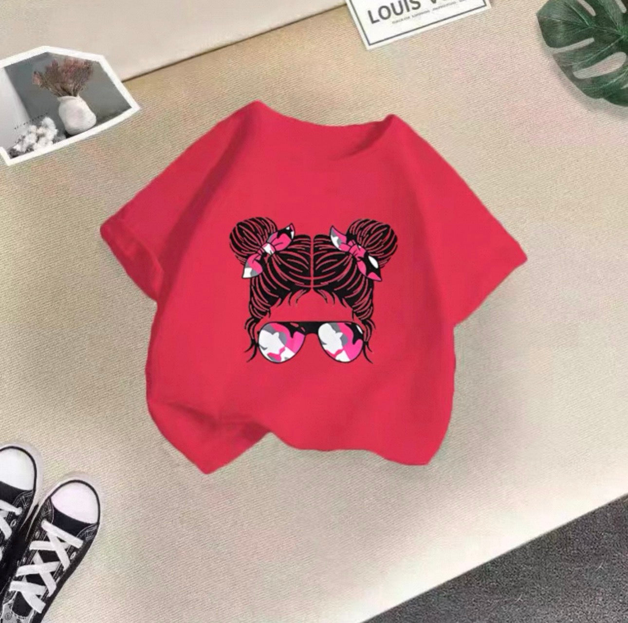 Red sweatshirt with a graphic design on a beige surface