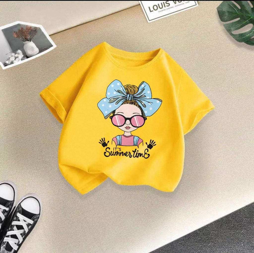 Yellow t-shirt with a cartoon design and 'It's Summer time' text on a textured surface.