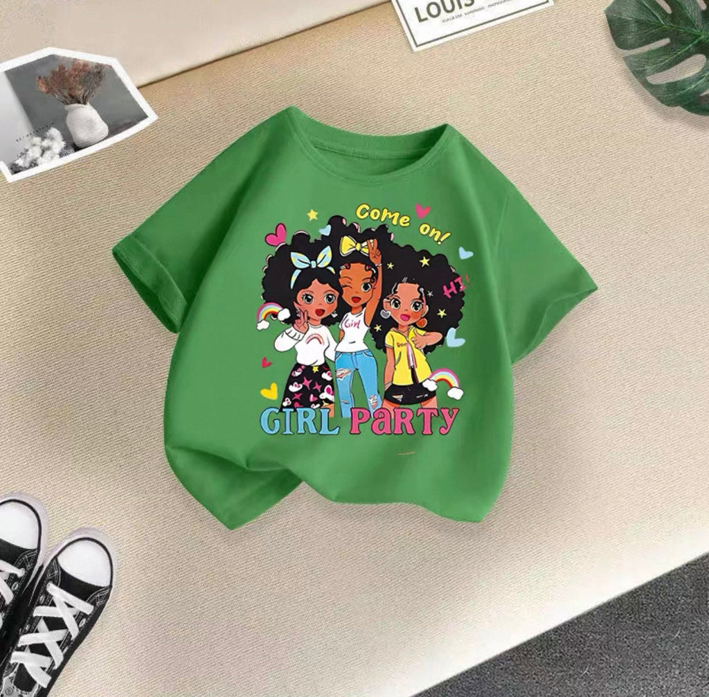 Green t-shirt with cartoon girls and text on a beige surface