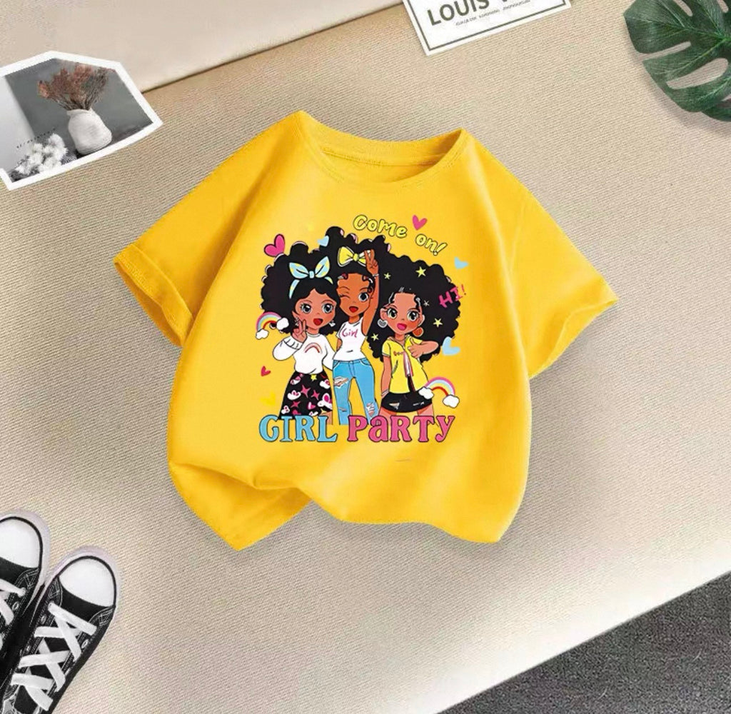 Yellow t-shirt with cartoon girls and 'Girl Party' text on a beige surface.