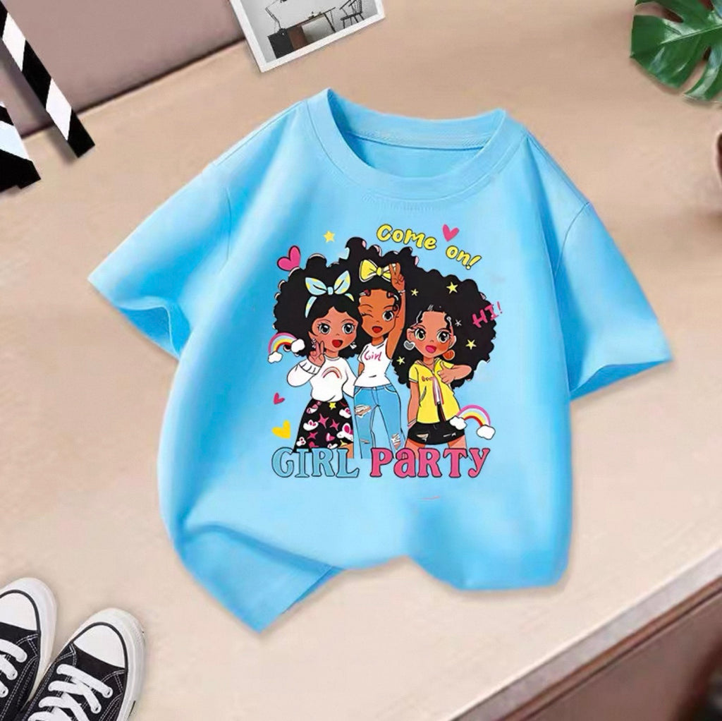 Light blue t-shirt with cartoon girls and text on a beige surface