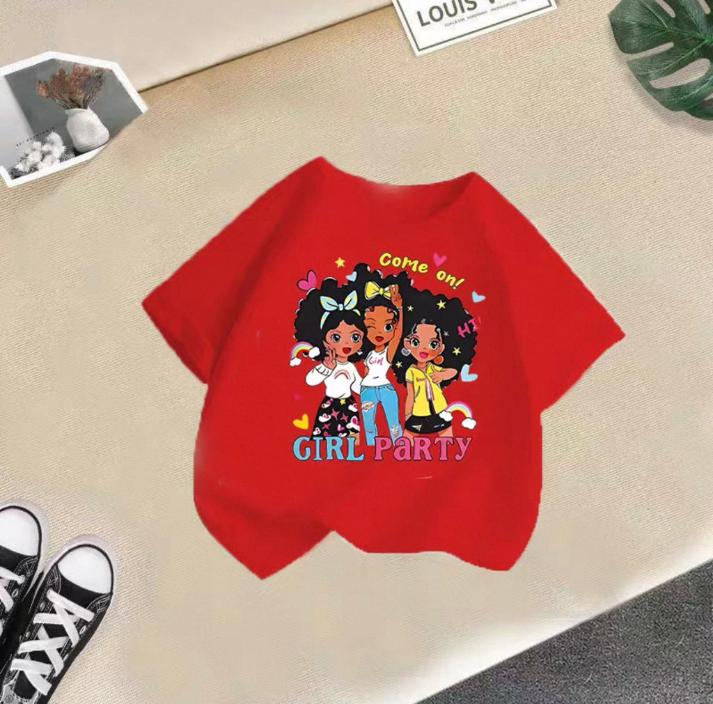 Red t-shirt with cartoon girls and text on a beige surface