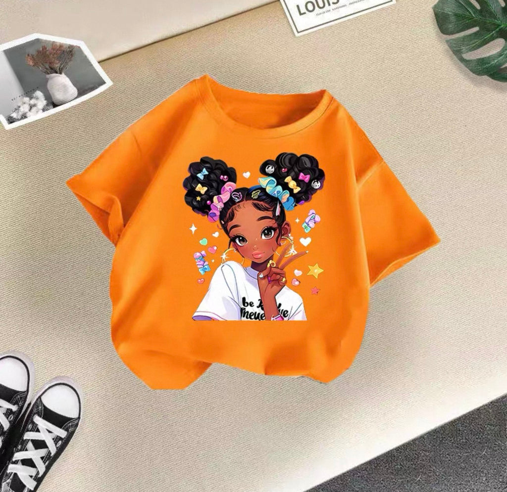 Orange sweatshirt with a graphic of a girl with braids on a beige surface.