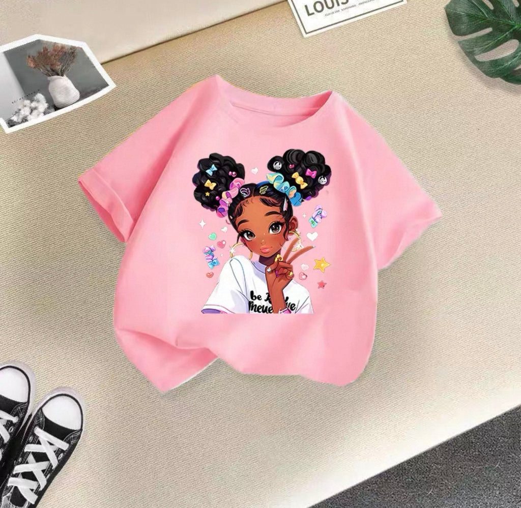 Pink t-shirt with a graphic of a girl with braids on a beige surface.