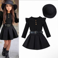 Black dress with ruffled sleeves and a hat on a white background
