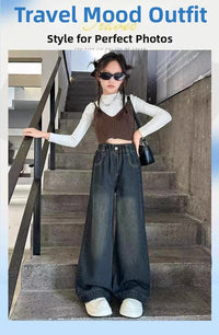 Person wearing a stylish outfit with a brown top and blue jeans standing on stairs.