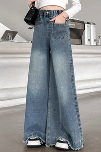 Person wearing wide-leg jeans in a casual setting
