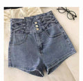 Blue denim shorts with button details on a light background