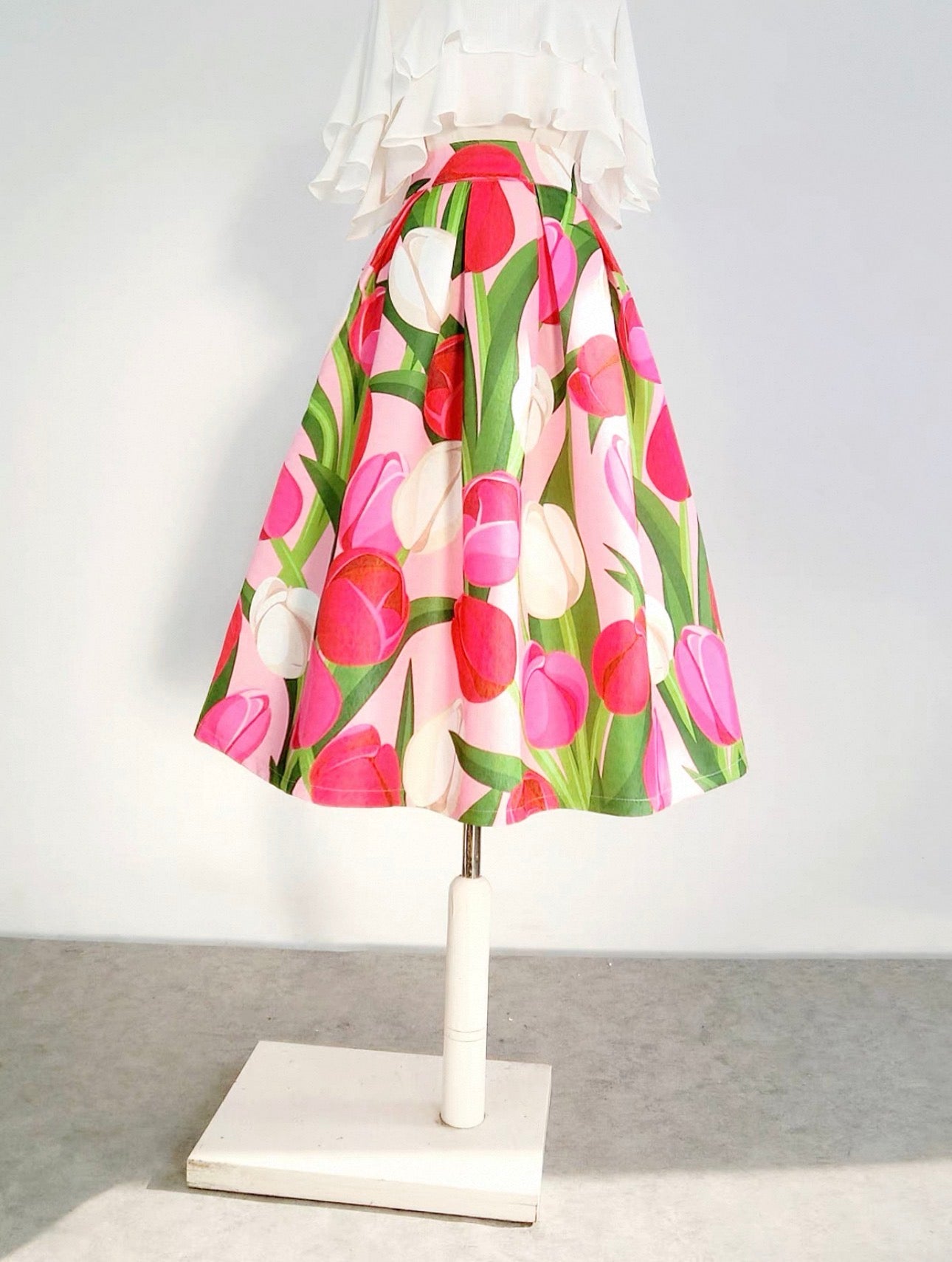 Floral skirt on a mannequin against a white background